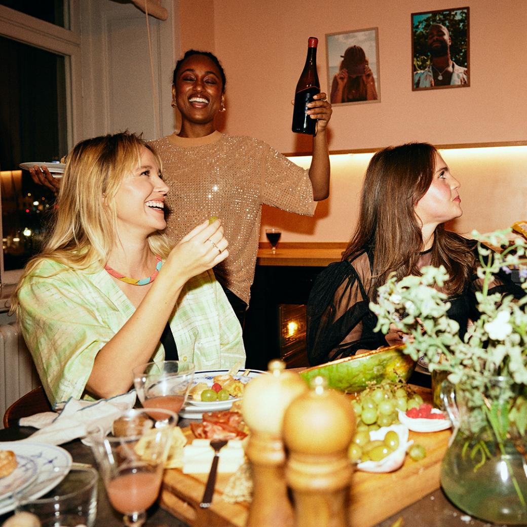 Friends celebrating with food and drinks