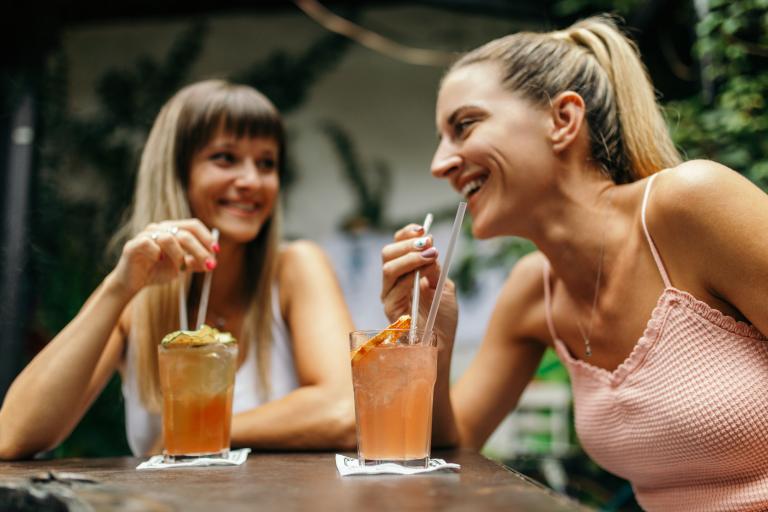 Friends chatting with drinks at a patio